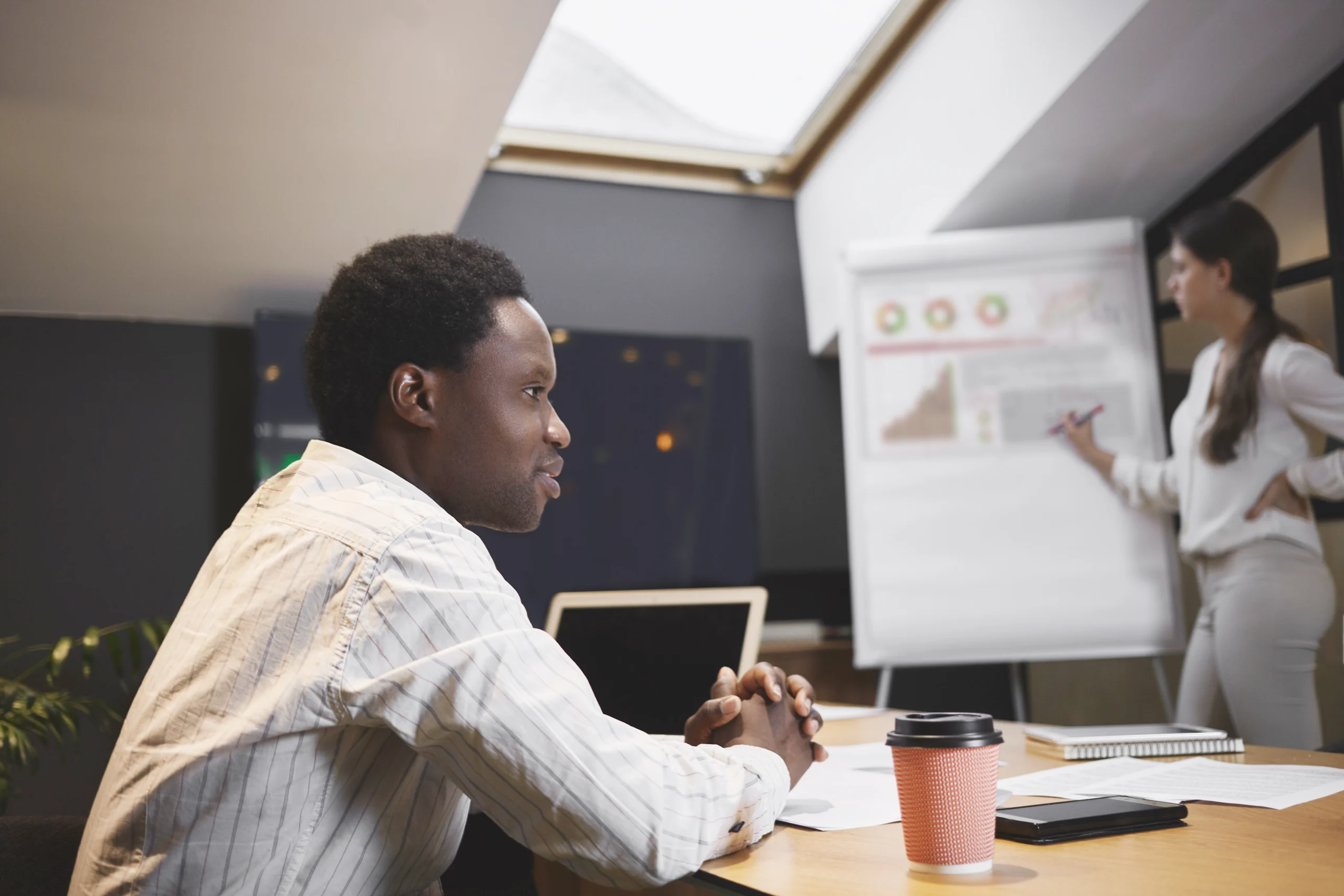 attractive-young-african-ceo-sitting-conference-room-meeting-developing-strategy
